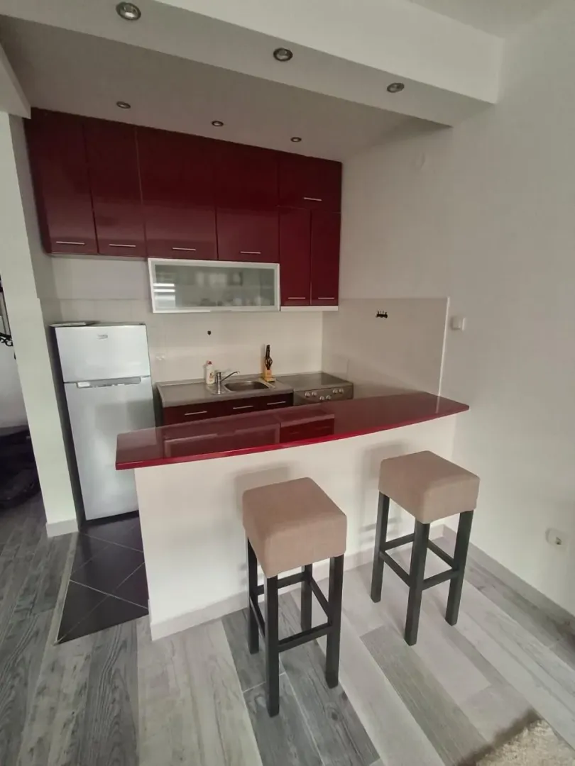Smaller kitchen with a breakfast bar and two bar stools.