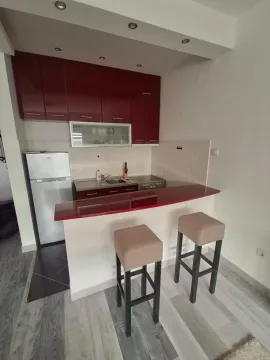Smaller kitchen with a breakfast bar and two bar stools. - image 17
