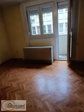 Empty room with parquet flooring, a window, and access to a balcony. - image 4