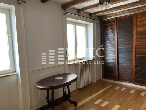 Furnished bedroom with a wooden wardrobe and a window. - image 17