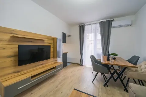 Living room with a wooden TV wall panel and a dining table. - image 7