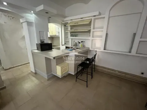 Smaller kitchen with a counter and bar stools. - image 4