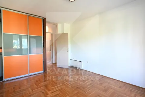 Empty bedroom with a built-in wardrobe and hardwood flooring. - image 11