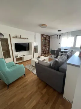 Spacious living room with a sofa set, TV, and dining area in the background. - image 8