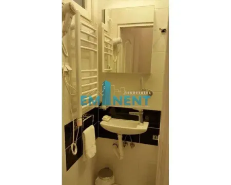 Small bathroom with a washbasin, mirror and wall-mounted towel holder. - image 12