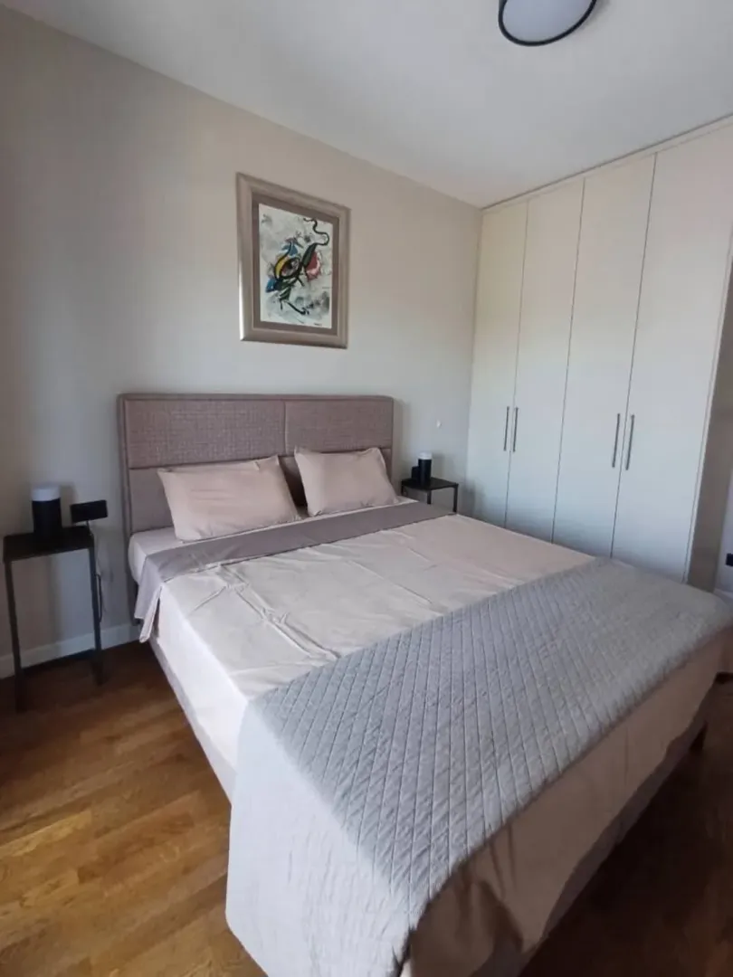 Furnished bedroom with a double bed and built-in wardrobe.
