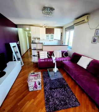 Living room with a sofa and a view towards the kitchen. - image 2