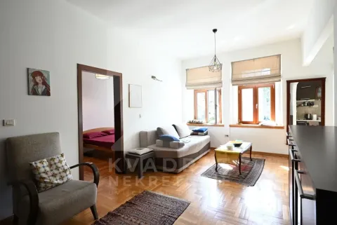 Living room with sofa, wooden floor and view of the windows. - image 4