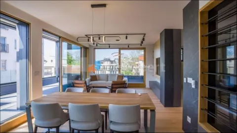 Spacious living room with a dining area and large glass surfaces. - image 21