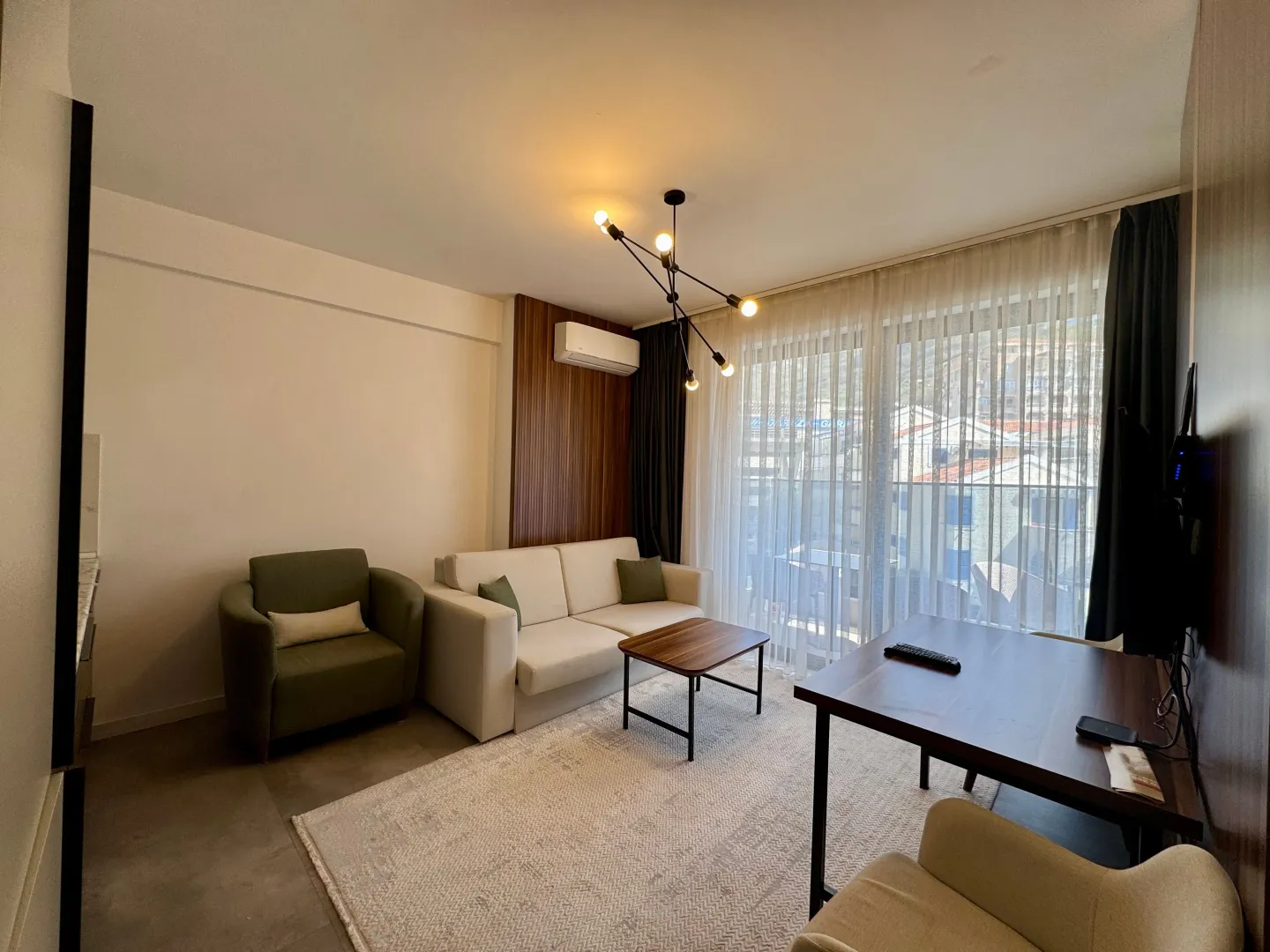 Modern living room with a sofa, coffee table, and dining table.