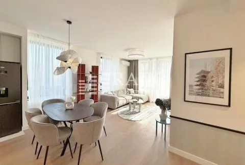 Living room with dining area and kitchen in light tones. - image 3