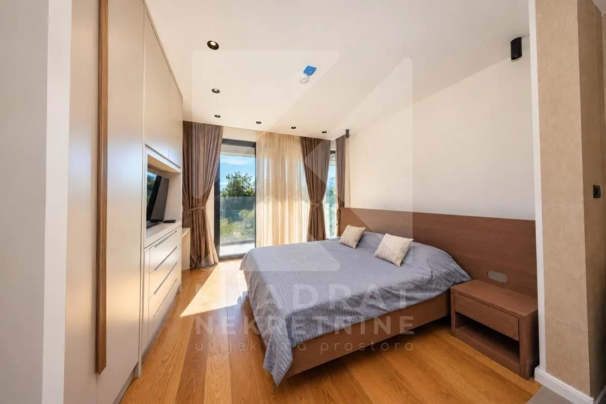 Modern bedroom with a double bed, built-in wardrobe, and access to the terrace.