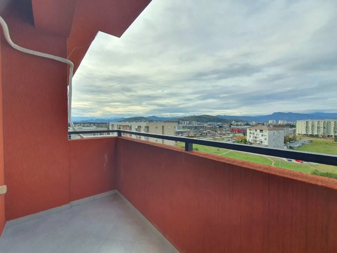 Covered balcony with a city view.
