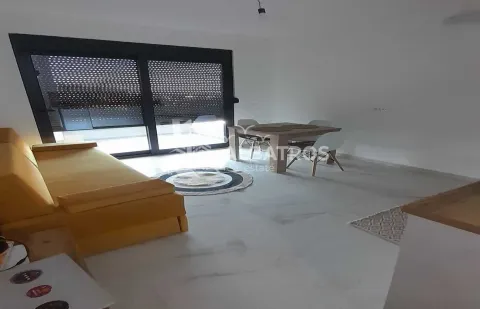 Living room with a sofa and dining table, with access to the terrace. - image 3