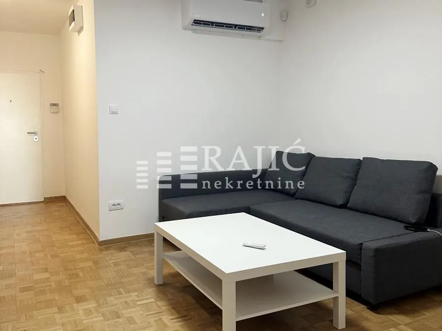 Living room with a sofa and a white coffee table.