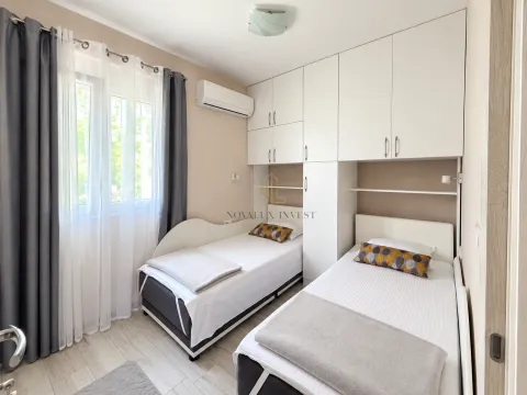 Bedroom with two single beds and fitted wardrobes. - image 8