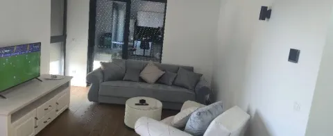 Furnished living room with a sofa set and television. - image 3