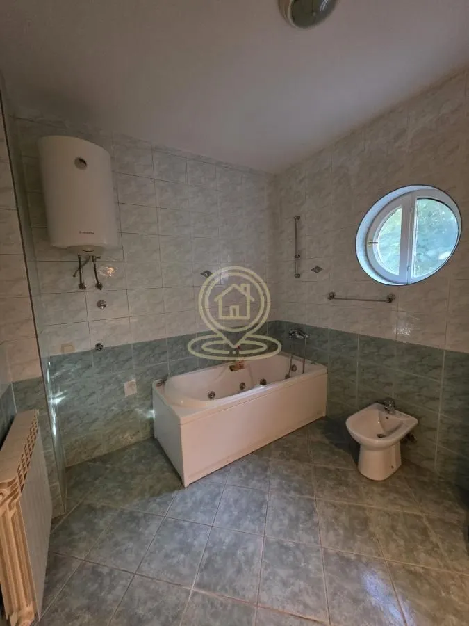 Bathroom equipped with a bathtub, bidet, and water heater.