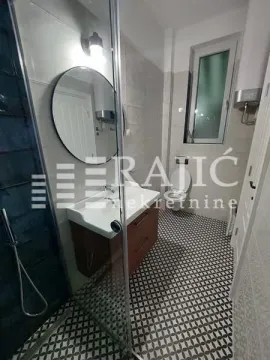Modern bathroom with a shower cabin, vanity, and toilet. - image 9