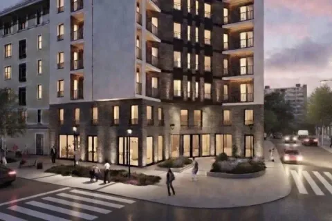 Exterior of a modern residential building with dusk lighting and a street in the foreground. - image 2