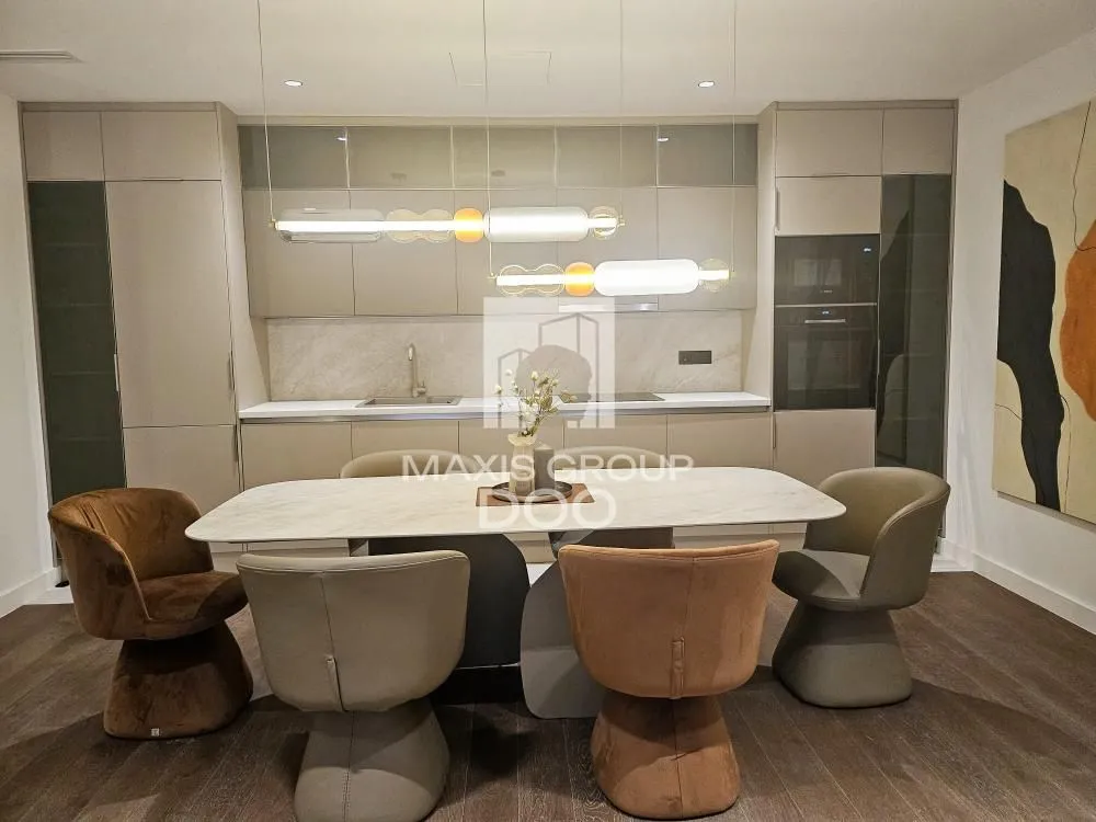 Modern kitchen with built-in cabinetry and a dining table with chairs.