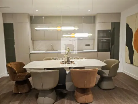 Modern kitchen with built-in cabinetry and a dining table with chairs. - image 7