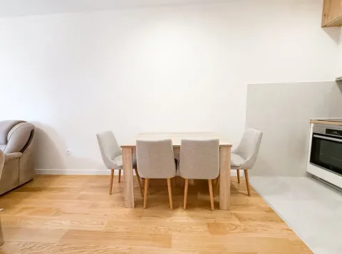 Dining table with chairs in the kitchen area. - image 4