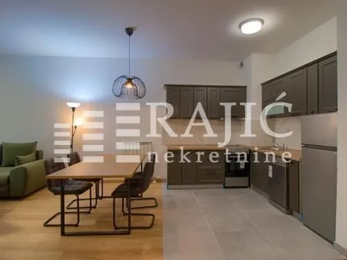 Modern kitchen with dining area and living room in an open space layout.