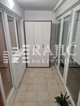 Enclosed balcony with a built-in wardrobe and ceramic floor tiles. - image 2