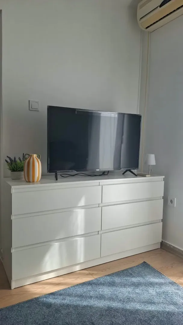 White chest of drawers with a TV in the living room.
