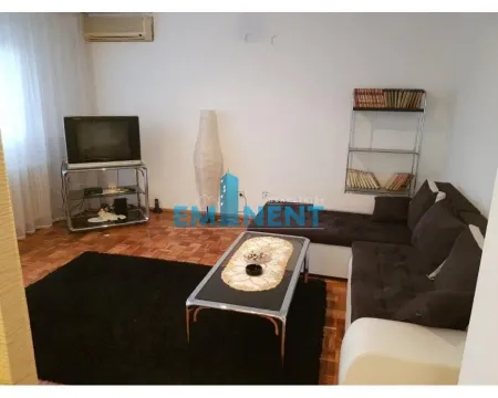 Living room with sofa, coffee table and television. - image 2