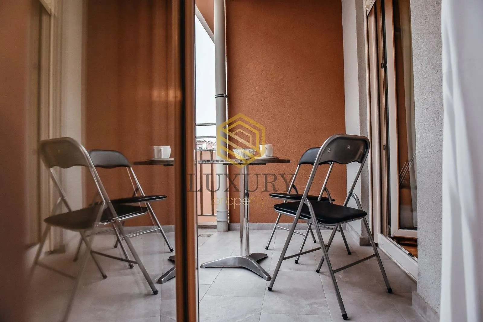 Small terrace with a table and chairs.