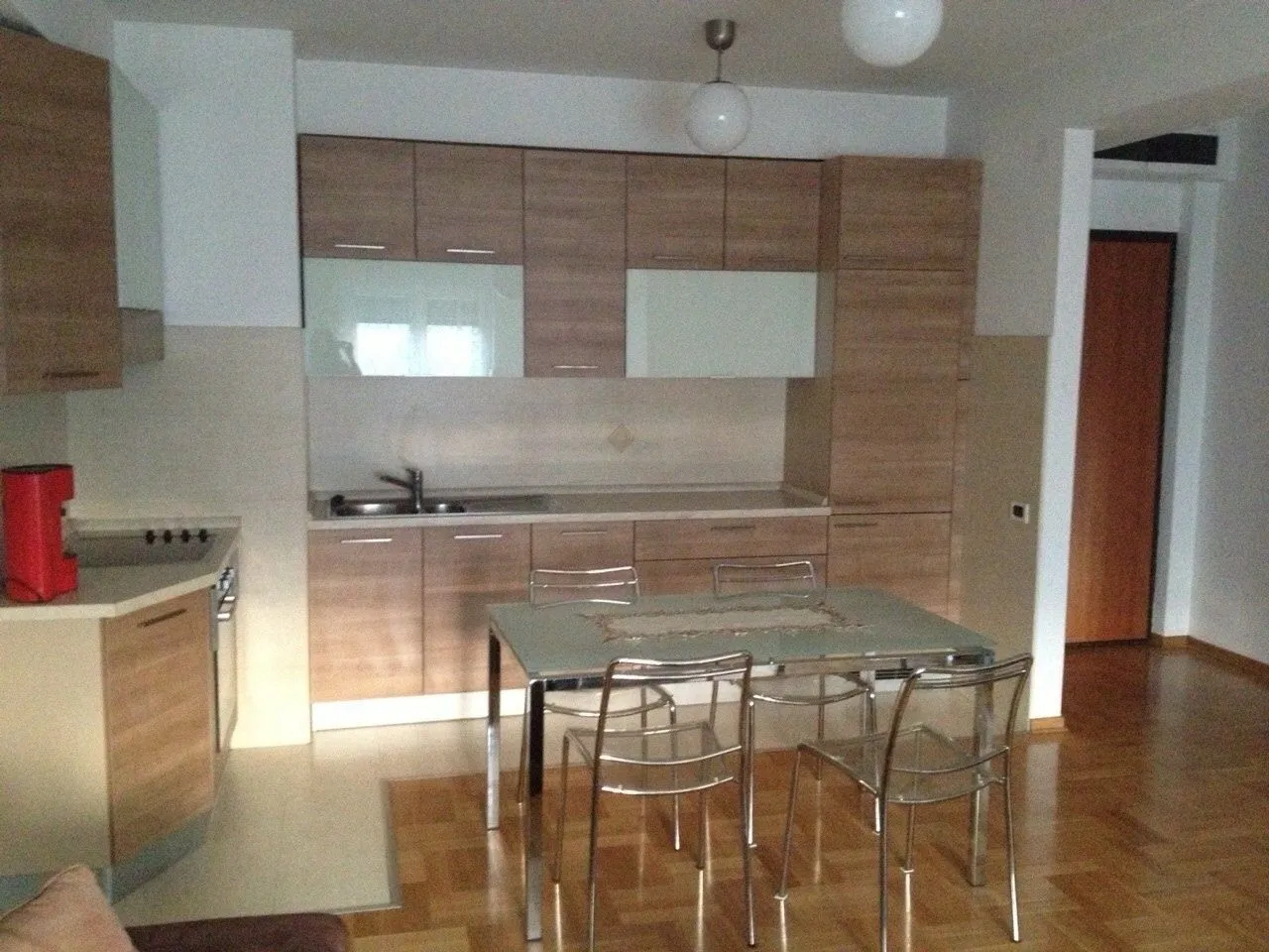 Bright kitchen with wooden cabinets and a dining table.