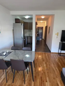 Living room with dining area and a view of the kitchen and hallway. - image 3