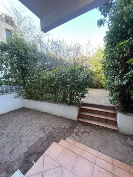 Paved yard with stairs and bushes. - image 13