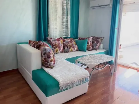 Living room with a sectional sofa, coffee table, and access to the terrace. - image 5