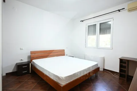 Furnished bedroom with a double bed and a window. - image 12