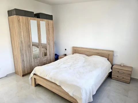 Furnished bedroom with a double bed, wardrobe, and nightstands. - image 6