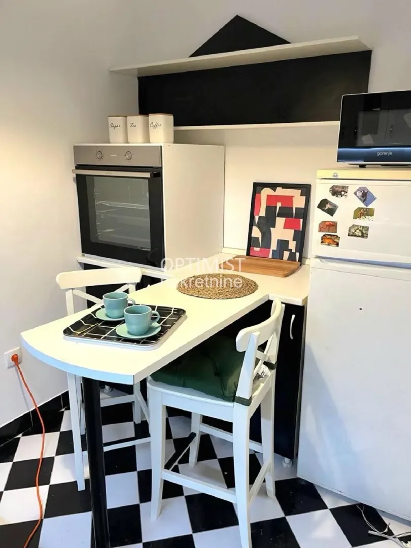 Small kitchen with a dining table and chairs.