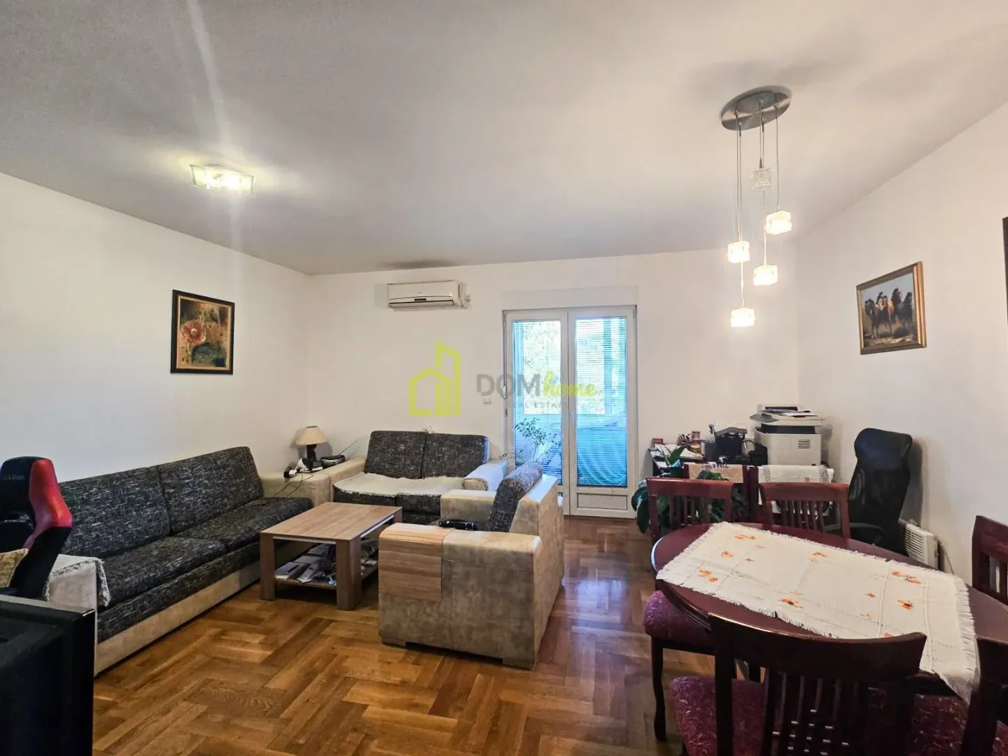 Spacious living room with seating furniture and a dining area.
