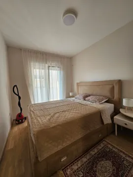 Furnished bedroom with a double bed and a window. - image 6