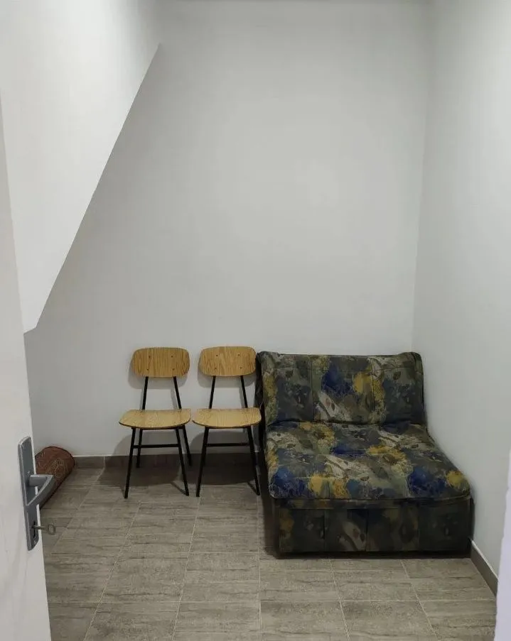 Small room with a small sofa and two chairs.