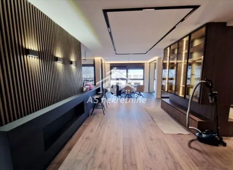 Spacious living room with modern wooden panels and wall lighting. - image 13