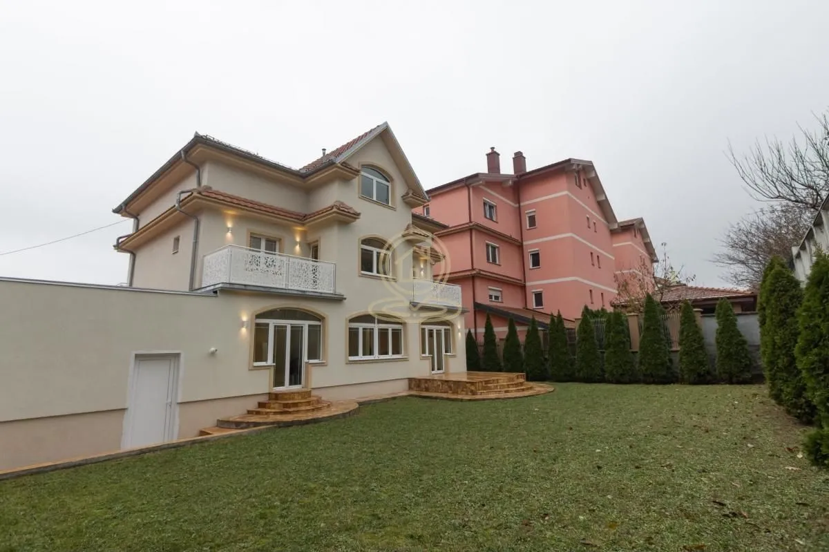 View of the back of the house with a landscaped yard and lawn.