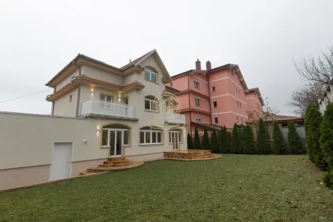 View of the back of the house with a landscaped yard and lawn. - image 3
