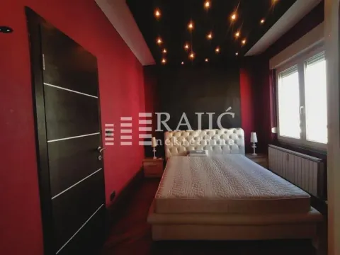 Modern bedroom with a double bed and decorative ceiling lighting. - image 9