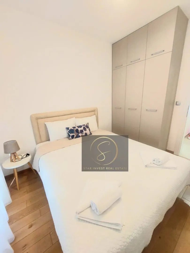 Bedroom with a double bed, white linens, and a built-in wardrobe.