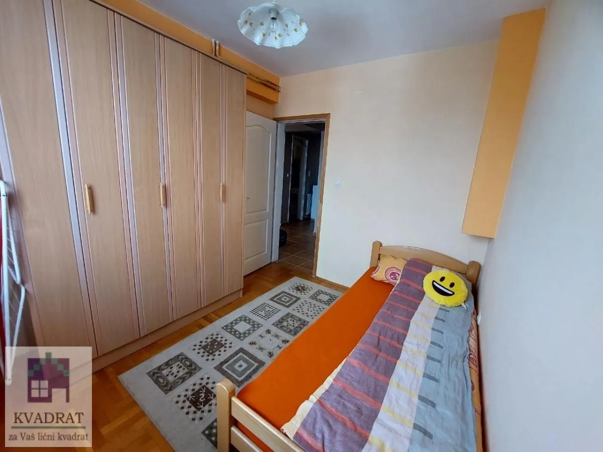 Smaller bedroom with a bed and a fitted wardrobe.