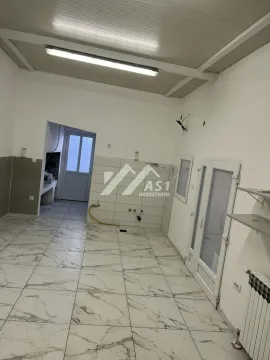Empty kitchen with tiled floor and walls. - image 2
