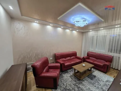 Living room furnished with red leather sofas and a wooden coffee table. - image 13